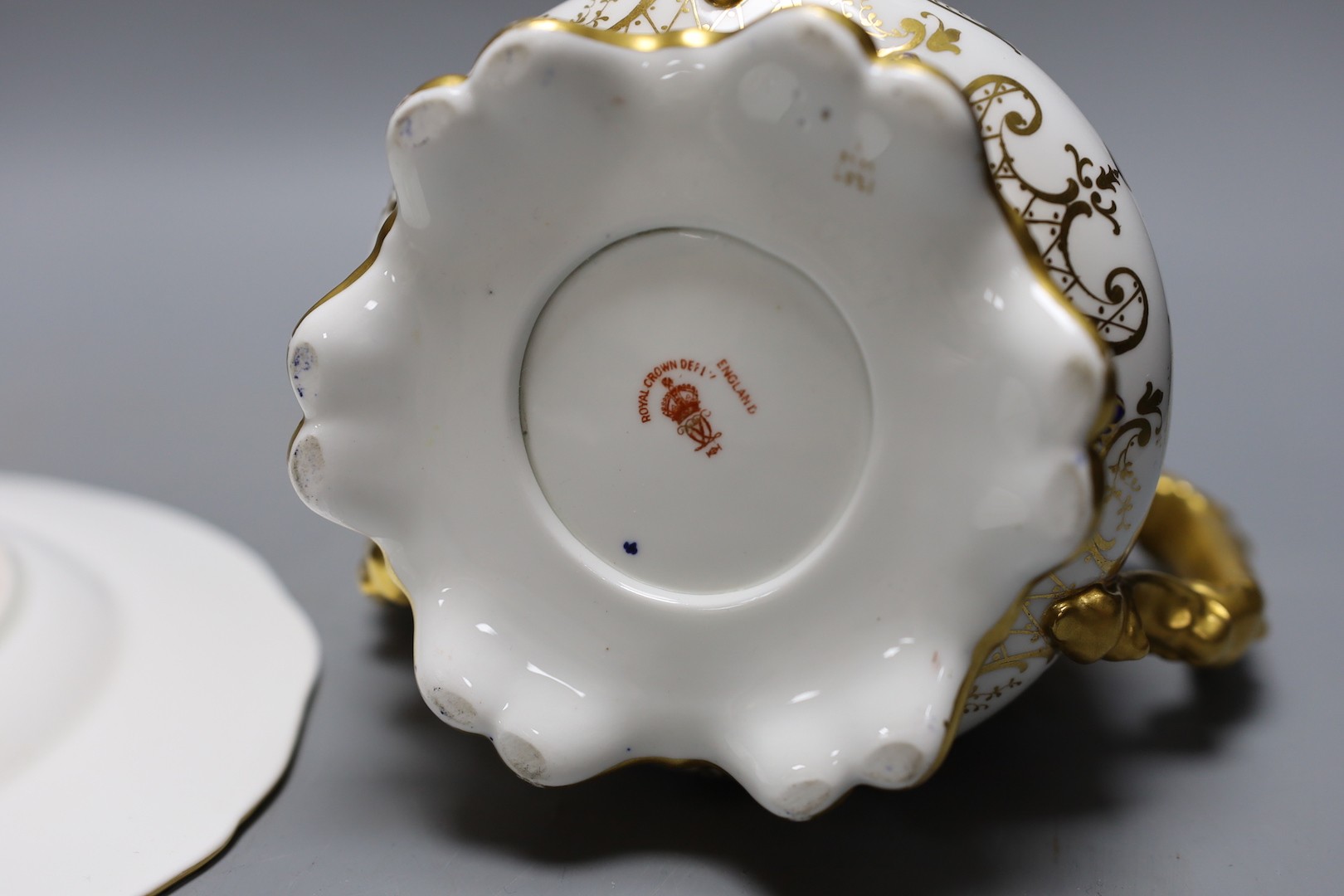 A Derby King Street plate by Harry Sampson Hancock monogrammed verso 'II' red S and H mark and a Royal Crown Derby three handled loving cups